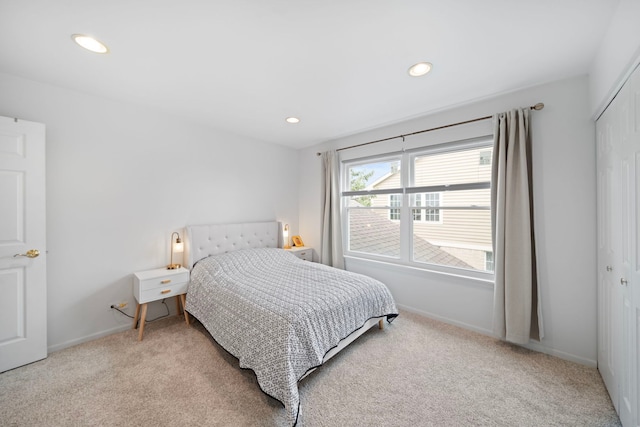 bedroom with recessed lighting, a closet, carpet, and baseboards