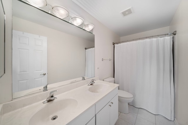 full bathroom featuring a sink, toilet, visible vents, and tile patterned floors