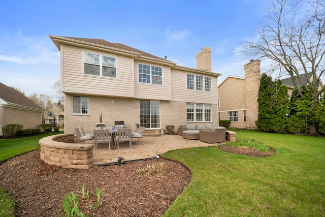 rear view of house featuring a patio, a chimney, a lawn, brick siding, and an outdoor hangout area