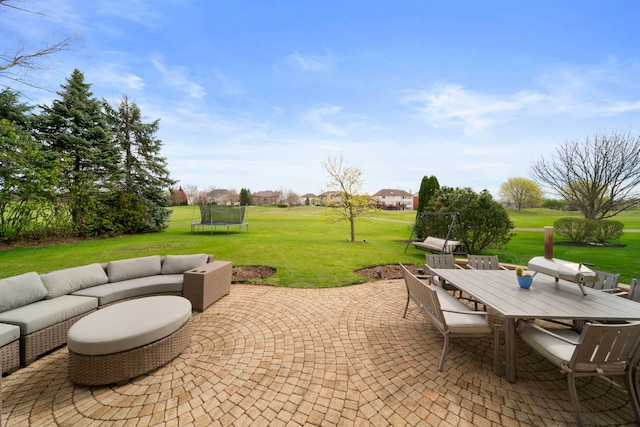 view of patio featuring an outdoor living space, a trampoline, and outdoor dining space