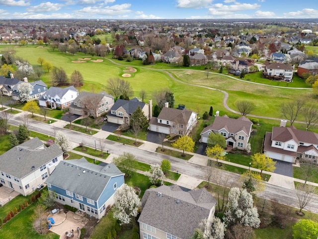 birds eye view of property with golf course view and a residential view