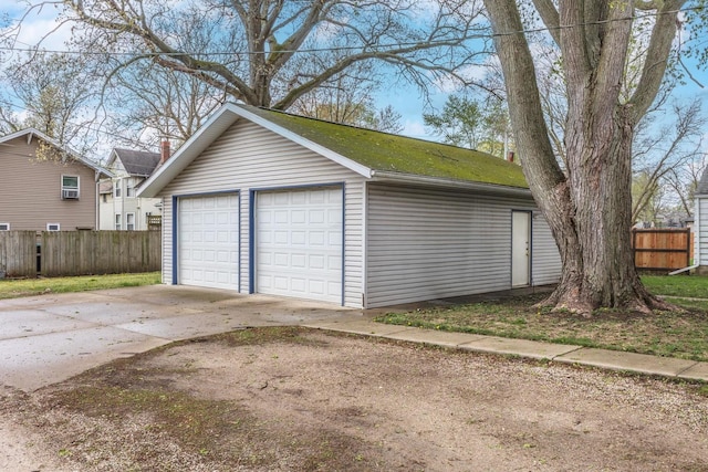 detached garage featuring fence