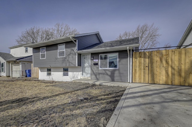 exterior space featuring brick siding and fence