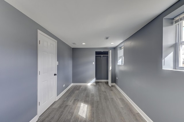 spare room with visible vents, baseboards, a healthy amount of sunlight, and wood finished floors