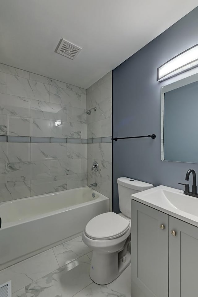 full bath featuring visible vents, marble finish floor, washtub / shower combination, and toilet