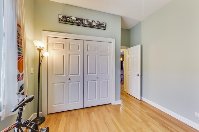 bedroom featuring baseboards, a closet, and light wood-style flooring