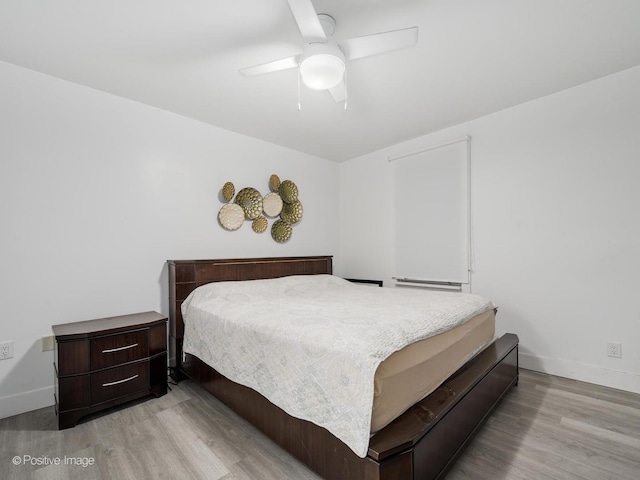 1812 W Erie St, Chicago, IL 60622 - bedroom with baseboards, a ceiling fan, and wood finished floors