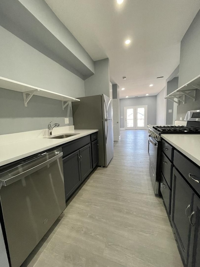 1812 W Erie St, Chicago, IL 60622 - kitchen with open shelves, a sink, light countertops, stainless steel appliances, and light wood-style flooring