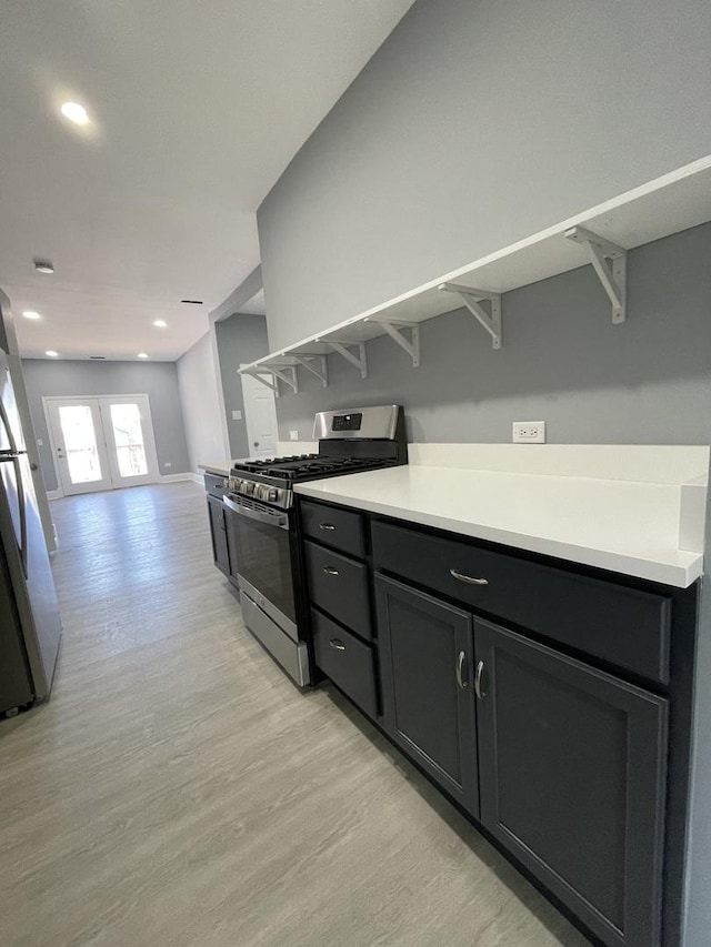 1812 W Erie St, Chicago, IL 60622 - kitchen with recessed lighting, appliances with stainless steel finishes, light countertops, open floor plan, and light wood finished floors