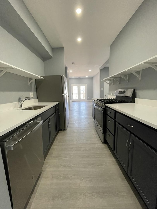 1812 W Erie St, Chicago, IL 60622 - kitchen with french doors, open shelves, light wood-style floors, appliances with stainless steel finishes, and a sink