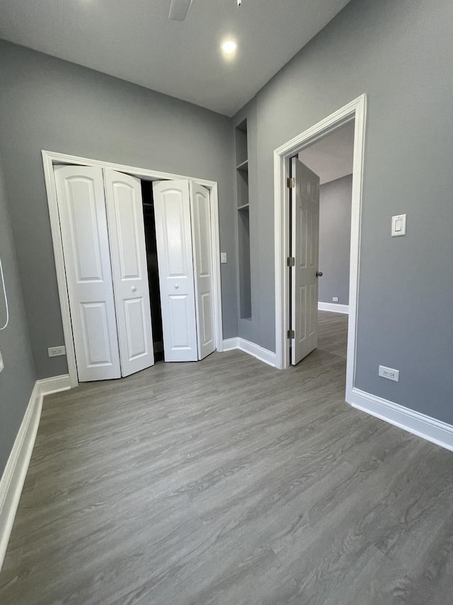 1812 W Erie St, Chicago, IL 60622 - unfurnished bedroom featuring ceiling fan, a closet, baseboards, and wood finished floors