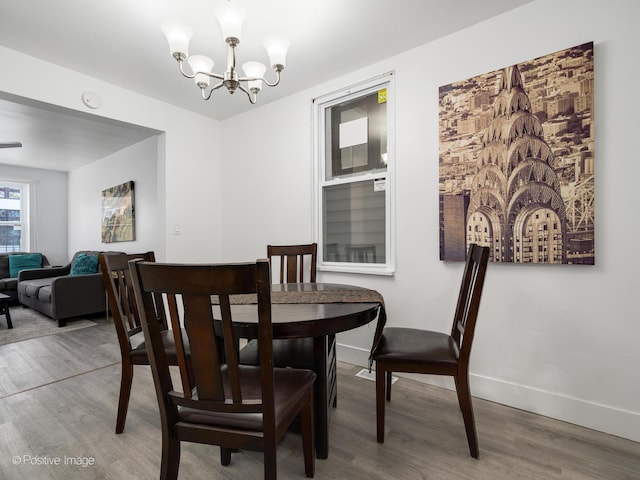 1812 W Erie St, Chicago, IL 60622 - dining area featuring wood finished floors, an inviting chandelier, and baseboards