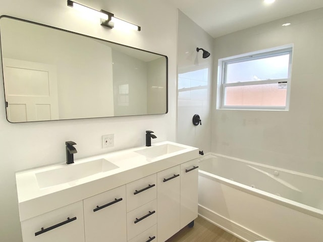 full bath featuring double vanity, shower / washtub combination, wood finished floors, and a sink