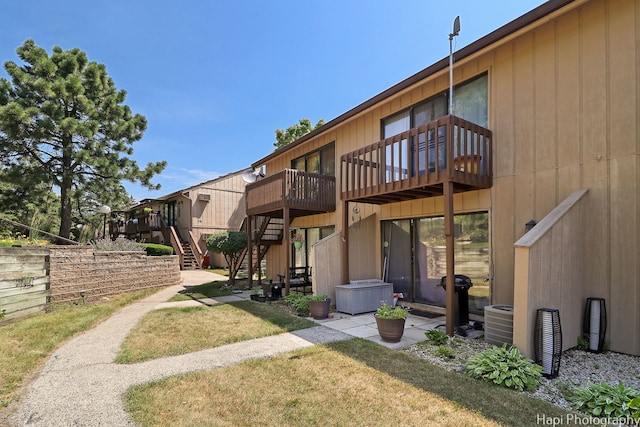 41 Bermuda Colony Unit 5, Fox Lake, IL 60020 - back of house with stairway, a lawn, and a wooden deck