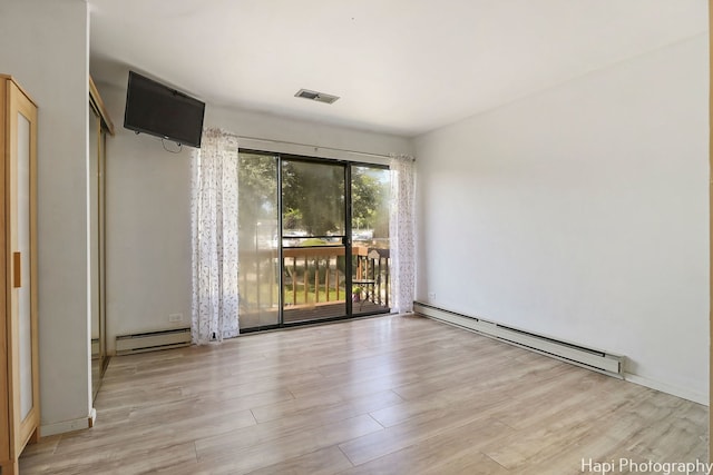41 Bermuda Colony Unit 5, Fox Lake, IL 60020 - spare room featuring a baseboard heating unit and wood finished floors