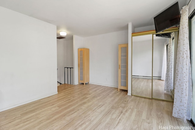 41 Bermuda Colony Unit 5, Fox Lake, IL 60020 - spare room featuring baseboard heating and wood finished floors