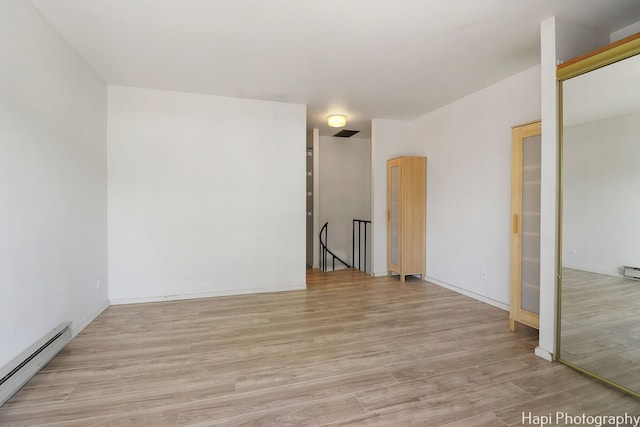 41 Bermuda Colony Unit 5, Fox Lake, IL 60020 - empty room featuring a baseboard heating unit and light wood-type flooring