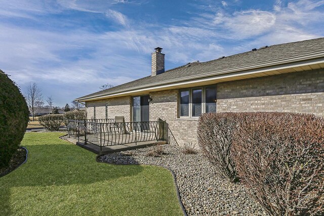 18148 Vermont Ct Unit 243, Orland Park, IL 60467 - back of property featuring brick siding, a lawn, a chimney, and a patio