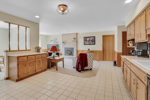 18148 Vermont Ct Unit 243, Orland Park, IL 60467 - kitchen with a wainscoted wall, light countertops, a brick fireplace, light tile patterned floors, and recessed lighting