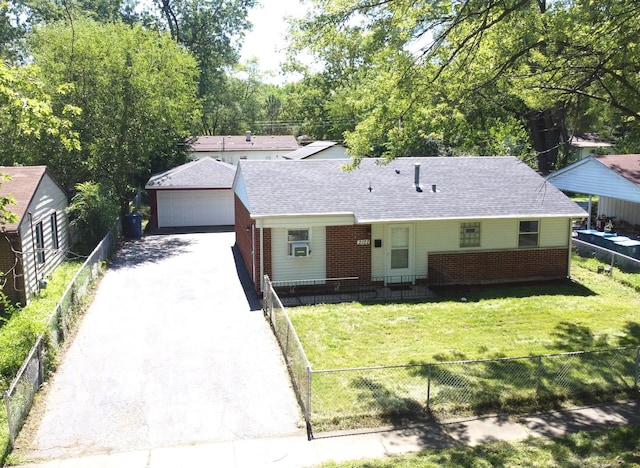 single story home with a front lawn, an outbuilding, brick siding, and a fenced front yard