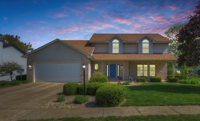 1310 Kimela Dr, Mahomet, IL 61853 - traditional-style home with driveway, a garage, a front lawn, a shingled roof, and covered porch