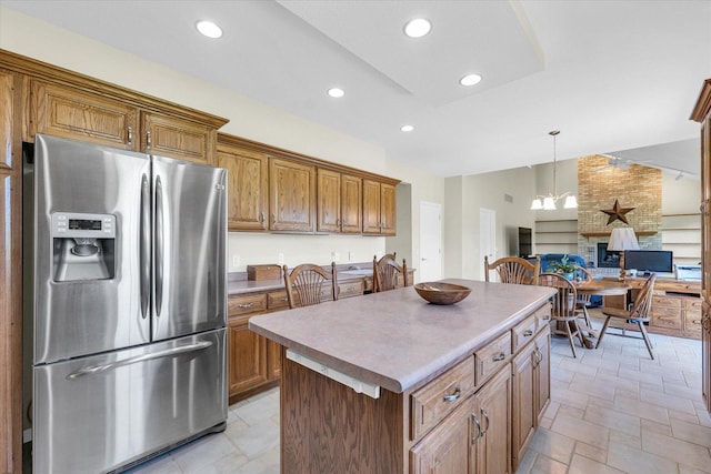 1310 Kimela Dr, Mahomet, IL 61853 - kitchen featuring stainless steel refrigerator with ice dispenser, brown cabinets, a center island, open floor plan, and recessed lighting