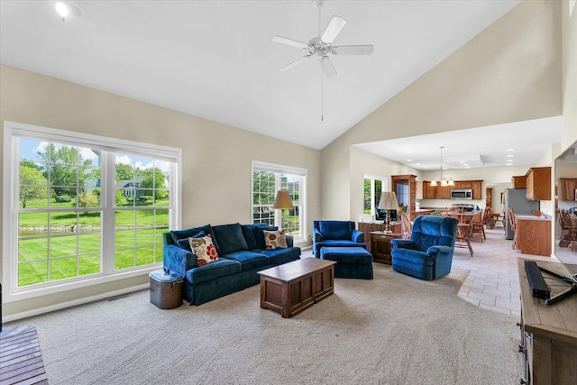 1310 Kimela Dr, Mahomet, IL 61853 - living room with light colored carpet, ceiling fan, and high vaulted ceiling