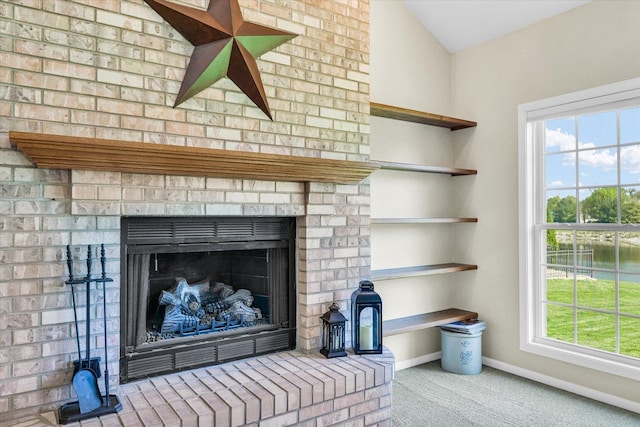 1310 Kimela Dr, Mahomet, IL 61853 - detailed view of carpet, baseboards, and a brick fireplace