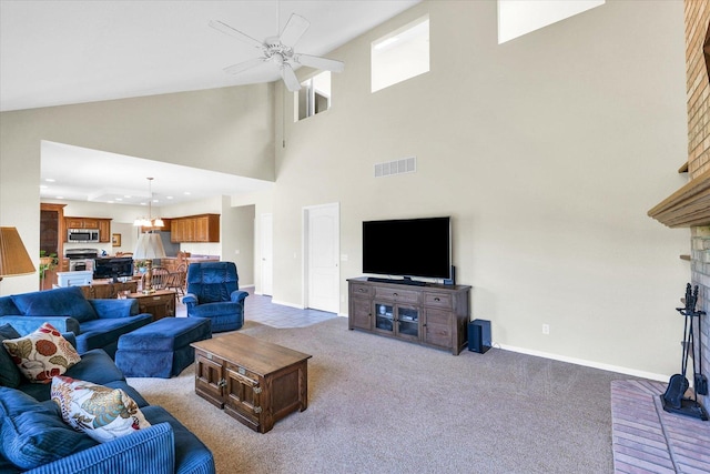 1310 Kimela Dr, Mahomet, IL 61853 - living room with ceiling fan, carpet floors, high vaulted ceiling, and baseboards