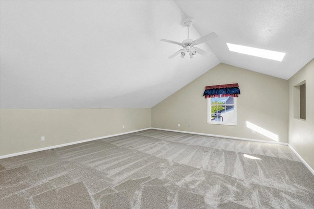 1310 Kimela Dr, Mahomet, IL 61853 - bonus room featuring lofted ceiling, carpet floors, ceiling fan, a skylight, and baseboards