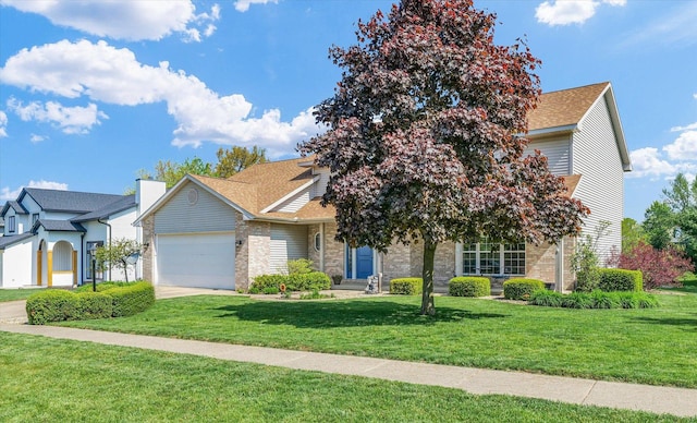 1310 Kimela Dr, Mahomet, IL 61853 - view of front of home with a garage, a front lawn, brick siding, a shingled roof, and concrete driveway