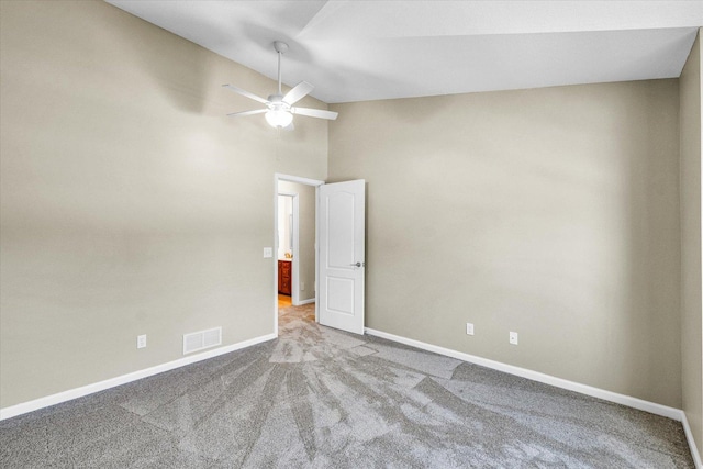 1310 Kimela Dr, Mahomet, IL 61853 - unfurnished room featuring lofted ceiling, carpet flooring, a ceiling fan, and baseboards
