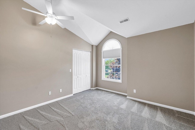 1310 Kimela Dr, Mahomet, IL 61853 - spare room featuring carpet, a ceiling fan, baseboards, and vaulted ceiling