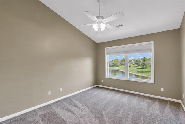 1310 Kimela Dr, Mahomet, IL 61853 - carpeted empty room featuring vaulted ceiling, baseboards, a ceiling fan, and a water view