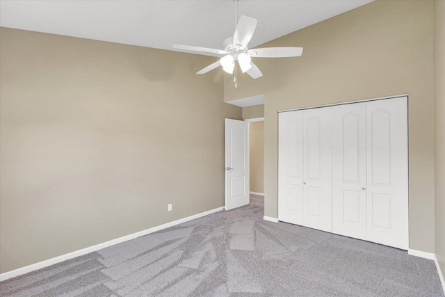 1310 Kimela Dr, Mahomet, IL 61853 - unfurnished bedroom featuring carpet floors, baseboards, high vaulted ceiling, a closet, and ceiling fan