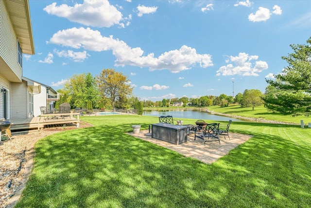 1310 Kimela Dr, Mahomet, IL 61853 - view of green lawn with a patio area and a deck with water view