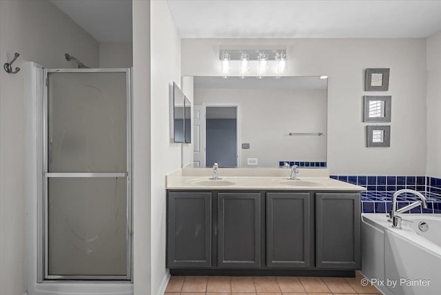 bathroom with a sink, double vanity, a bath, and a shower stall