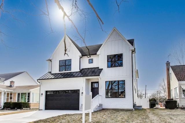 modern farmhouse with a standing seam roof, a garage, board and batten siding, and driveway