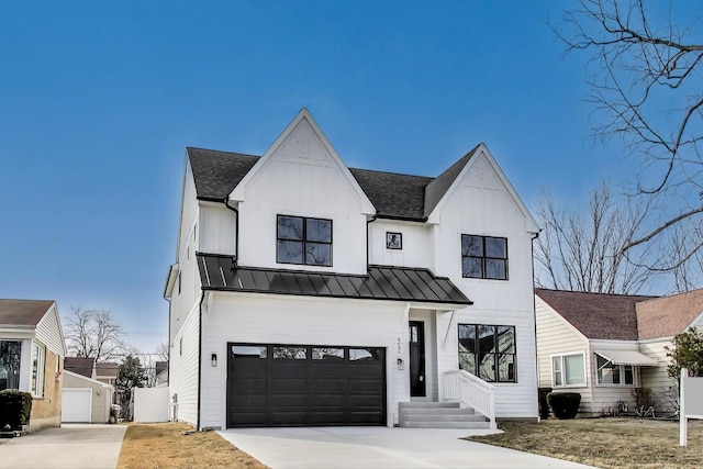 modern inspired farmhouse featuring board and batten siding, concrete driveway, metal roof, an attached garage, and a standing seam roof