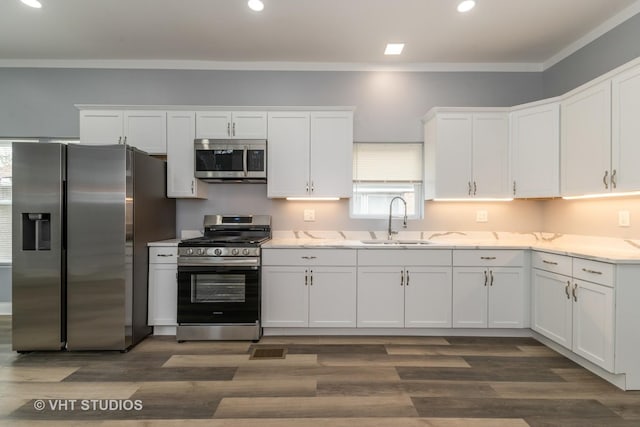 2017 W 68th St, Chicago, IL 60636 - kitchen with appliances with stainless steel finishes, a sink, white cabinets, recessed lighting, and crown molding