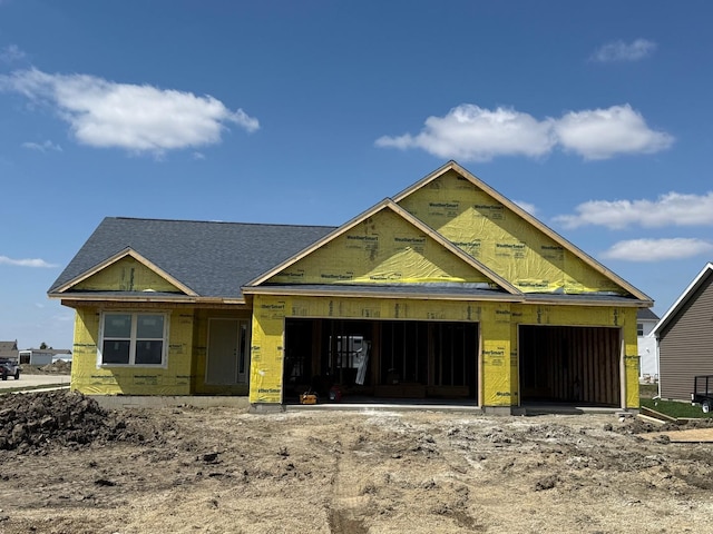 property under construction featuring driveway and an attached garage