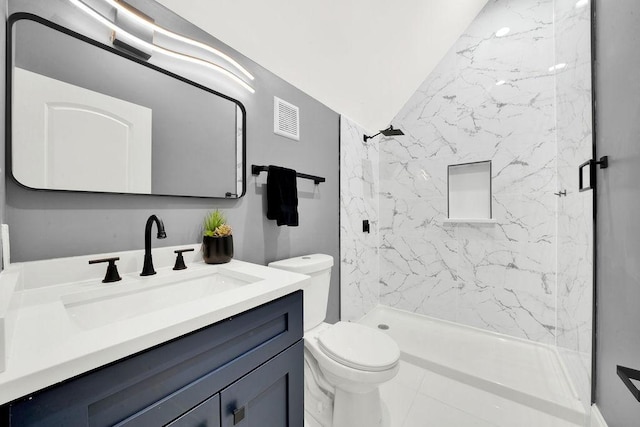 bathroom featuring vanity, visible vents, a marble finish shower, vaulted ceiling, and toilet