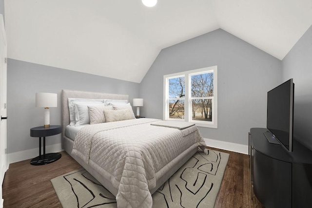 bedroom featuring vaulted ceiling, wood finished floors, and baseboards