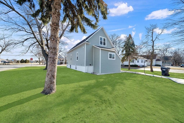 view of property exterior featuring a lawn