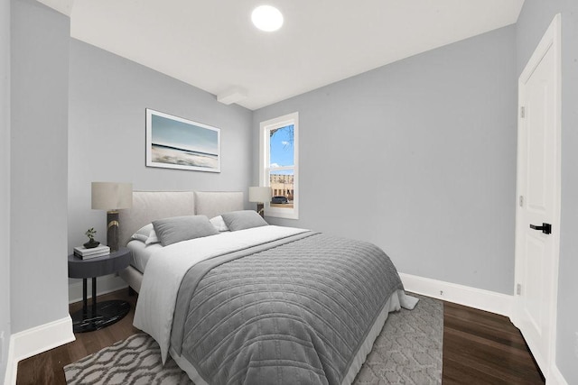 bedroom featuring wood finished floors and baseboards