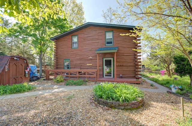 64 Big Musky Circle Ln, Wilmington, IL 60481 - back of property with log siding and a wooden deck