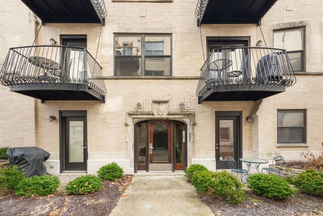 4434 N Damen Ave Unit 3W, Chicago, IL 60625 - view of exterior entry featuring a balcony and brick siding