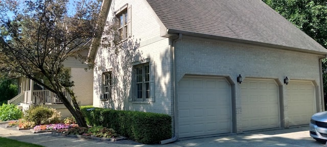 3048 Brampton Ln, Dyer, IN 46311 - view of side of home featuring brick siding, concrete driveway, roof with shingles, and a garage