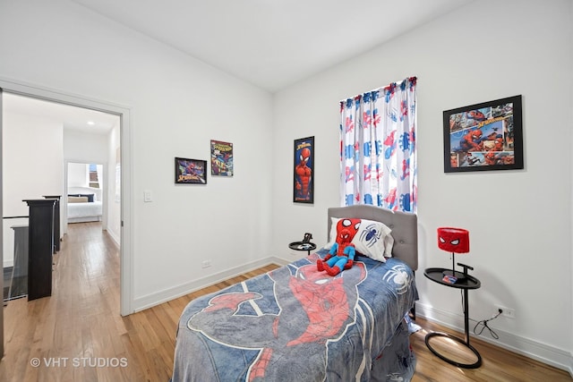 bedroom featuring baseboards and light wood-type flooring