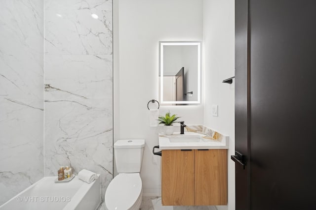 bathroom featuring vanity, toilet, and marble finish floor